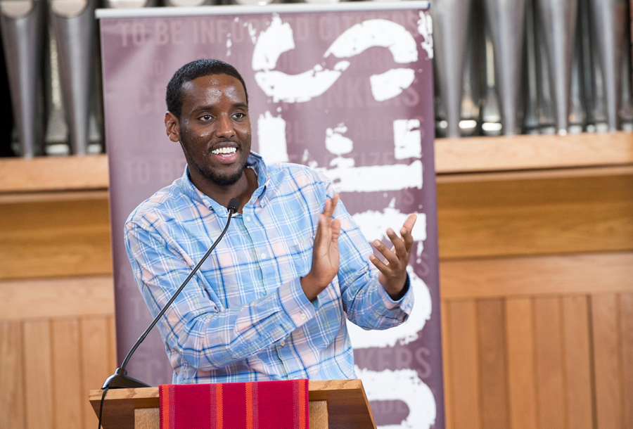 Augsburg student speaks to the crowd from the podium